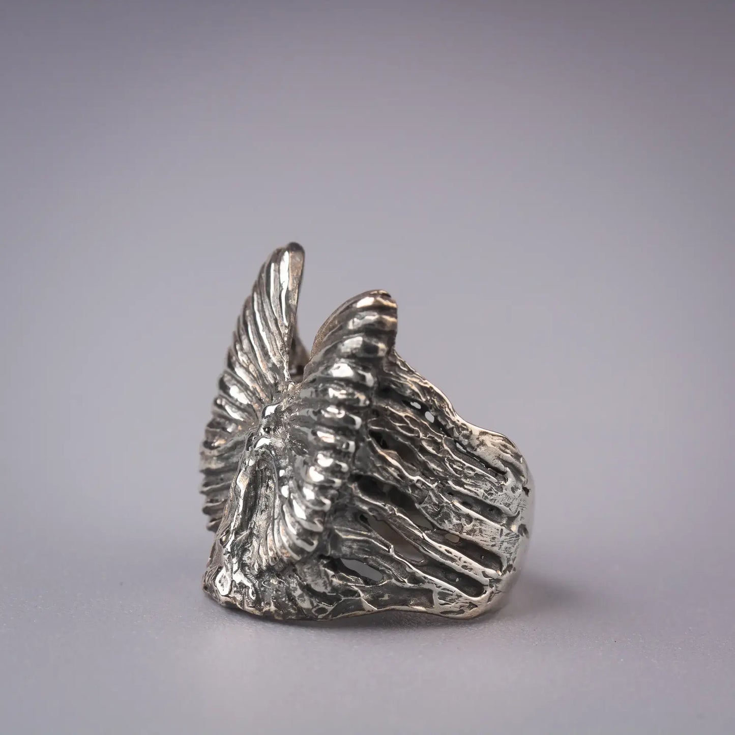 Artistic sterling silver angel ring with abstract wing design, symbolizing grace and spirituality.