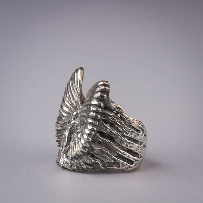 Artistic sterling silver angel ring with abstract wing design, symbolizing grace and spirituality.