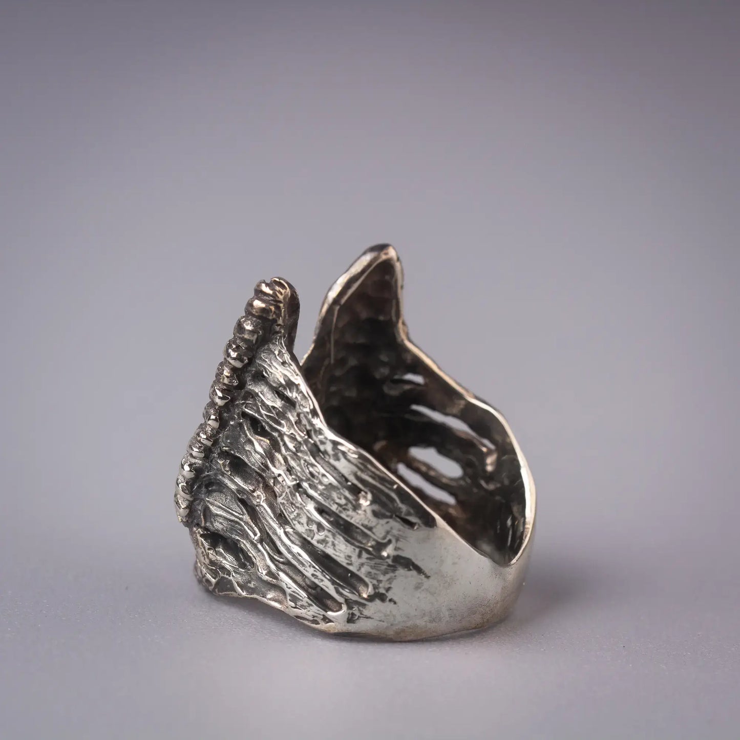 Sterling silver angel wing ring, handcrafted spiritual statement piece with guardian symbolism and artistic design.