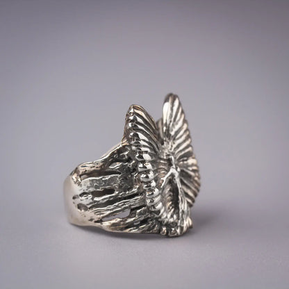 Sterling silver guardian angel ring with abstract wings, spiritual artistic statement piece.