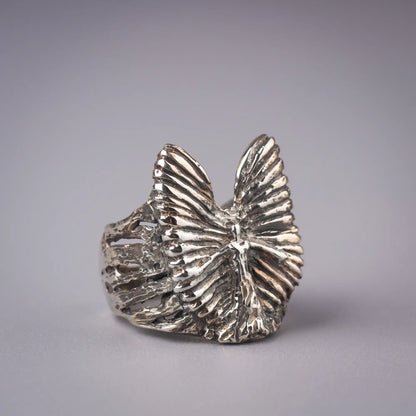 Sterling silver angel wing statement ring with abstract design, guardian symbol, artistic spiritual jewelry piece.