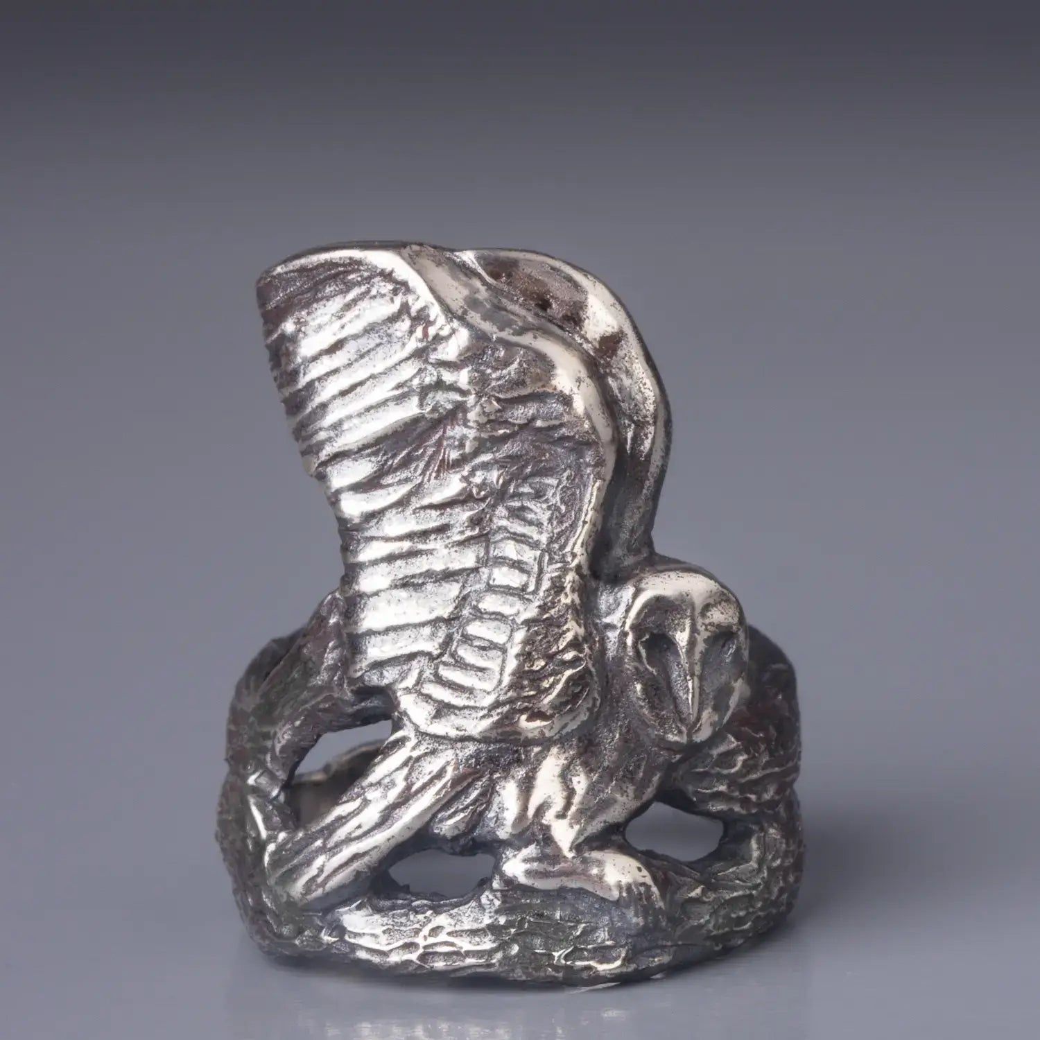 Barn Owl Ring in Sterling Silver with owl spreading wings, hand-carved bird statement ring sitting on a branch, front view.