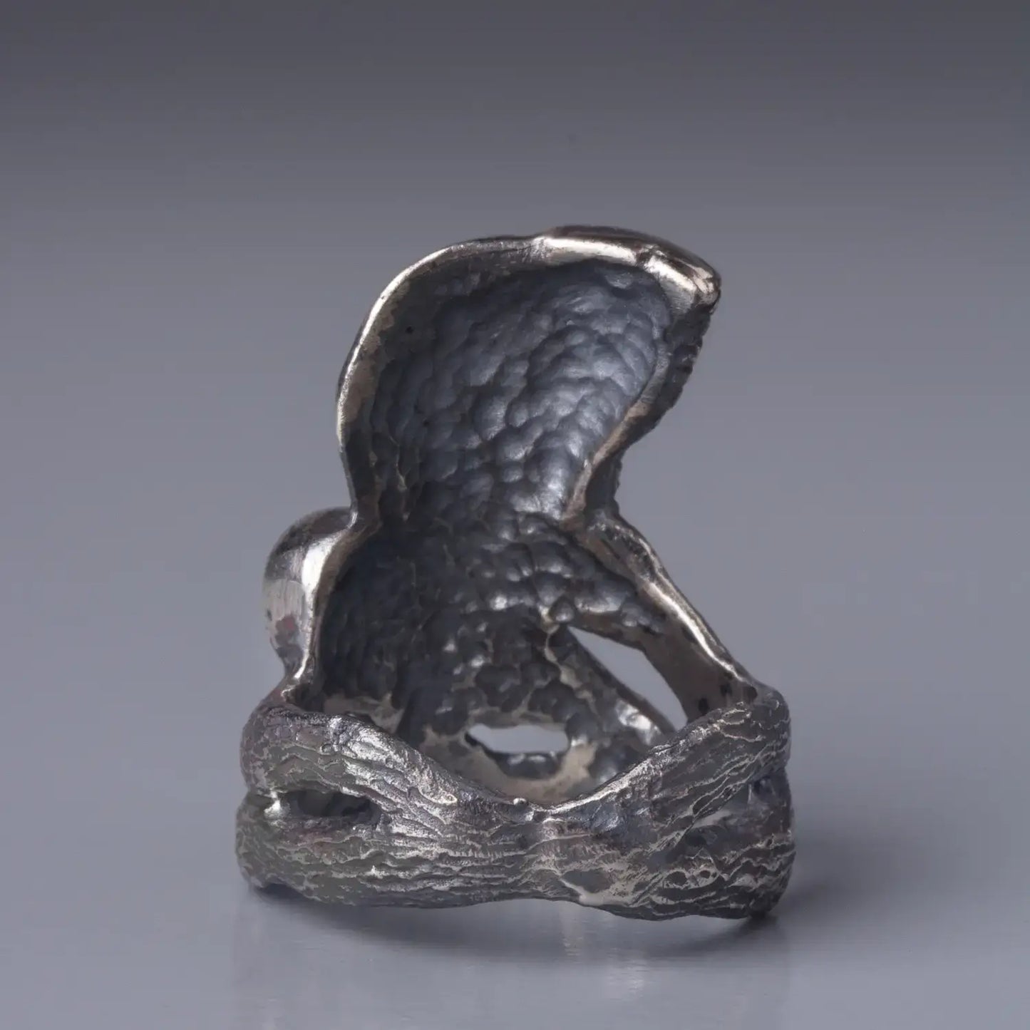 Sterling silver Barn Owl ring showing detailed back design, bird with wings spread sitting on a branch, back view.