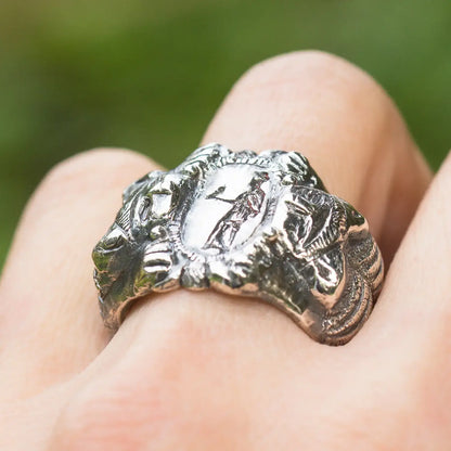 Roman Etruscan antique style sterling silver signet ring with lion and goddess design on finger, handmade artisan mythology ring.