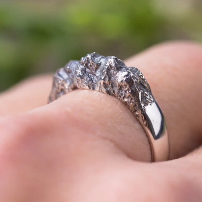 Sterling silver mountain range ring with textured rock design worn on finger, showcasing organic and nature-inspired style for women.