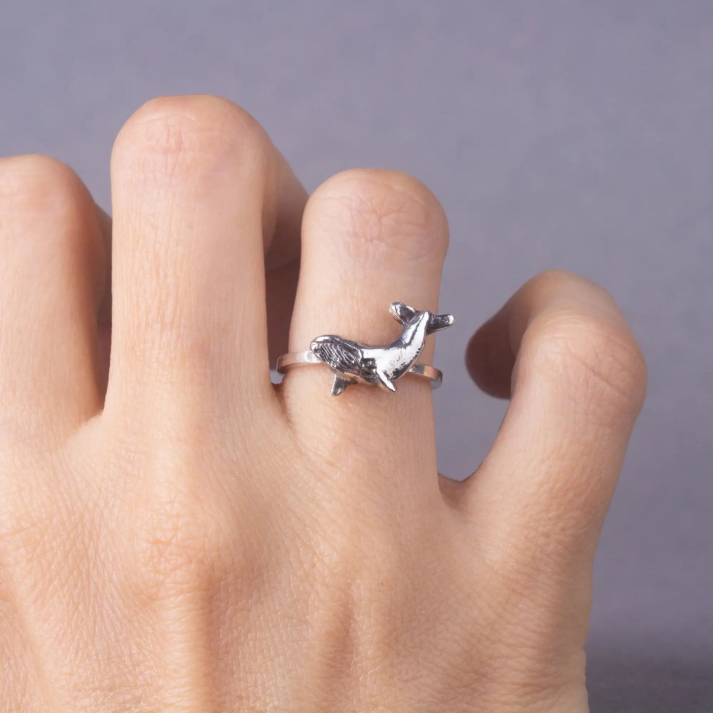 Humpback whale ring in silver, worn on finger