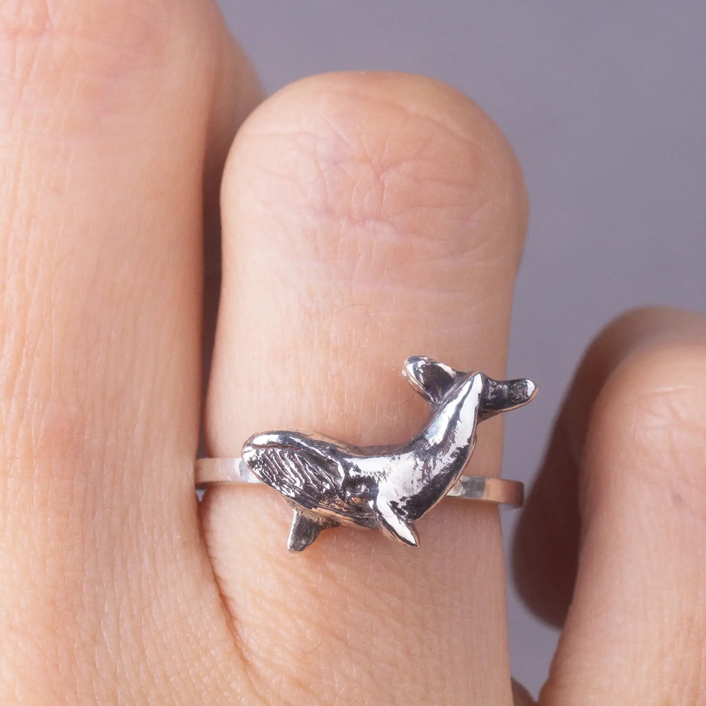 whale dainty ring in silver, worn on finger