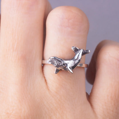 Humpback whale dainty ring in silver, worn on finger