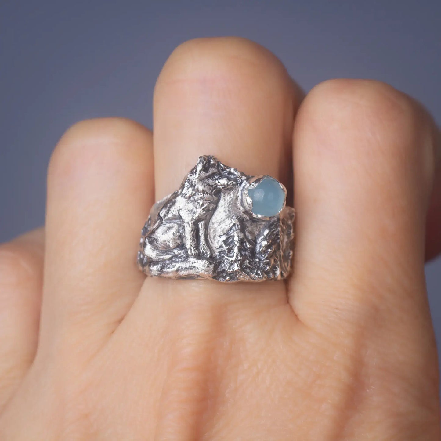 wolf ring in silver with aquamarine Gemstone back view worn on finger