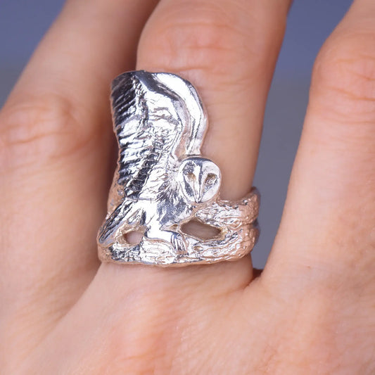 Sterling silver barn owl ring on finger, featuring nature-inspired design and intricate details, perfect for woodland and spirit animal enthusiasts.