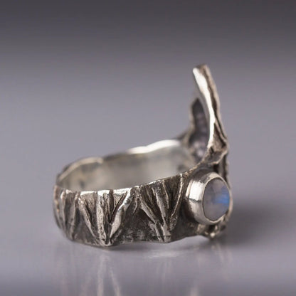 Sterling silver bat ring with detailed bat wings and a gemstone, showcasing nature-inspired design and animal motif.