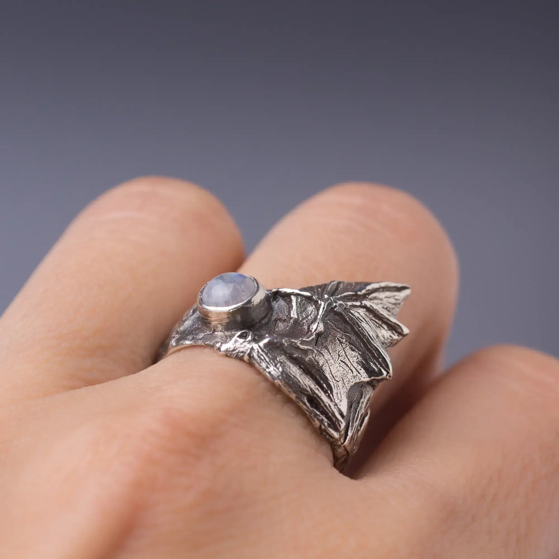 Sterling silver bat ring with gemstone, featuring detailed bat wings and witchy design. Perfect nature and animal-themed jewelry piece.