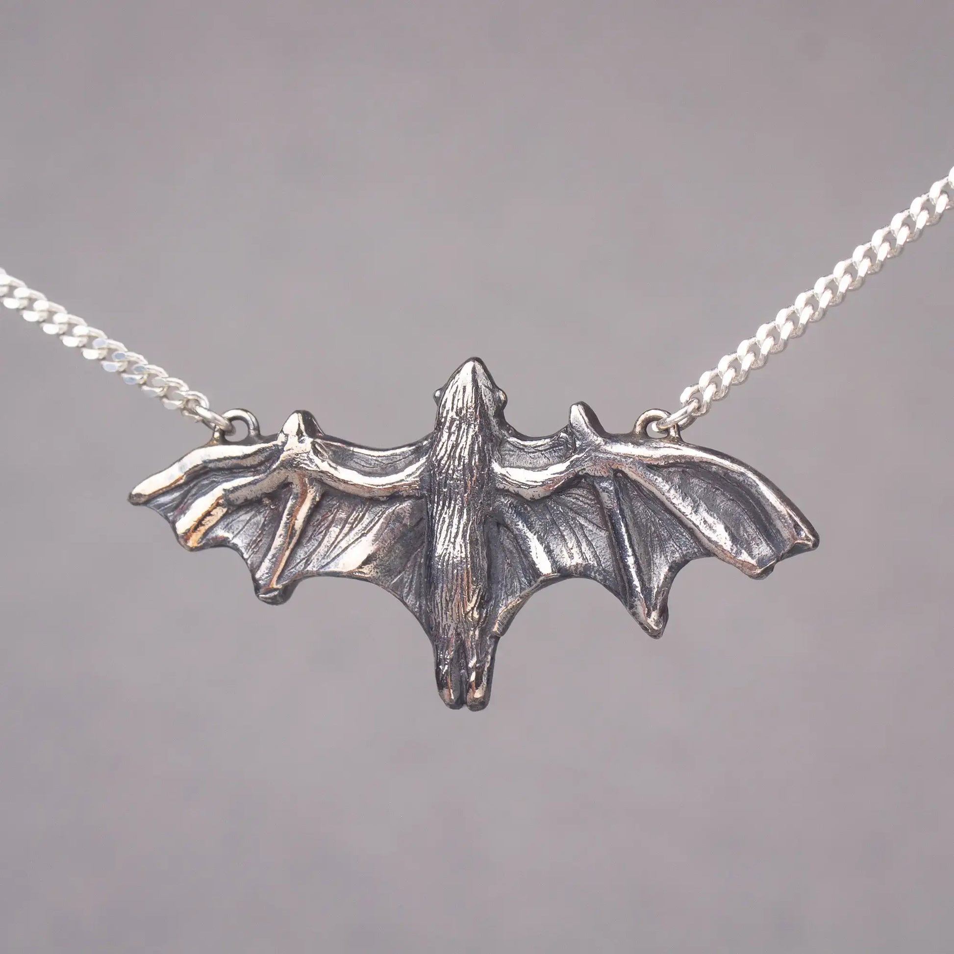 Sterling silver fruit bat pendant necklace, bold statement jewelry, featuring large flying bat design, perfect for bat lovers and Halloween.