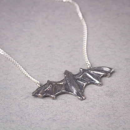 Sterling silver bat pendant necklace featuring a large flying bat design, perfect for a bold statement piece or Halloween jewelry.