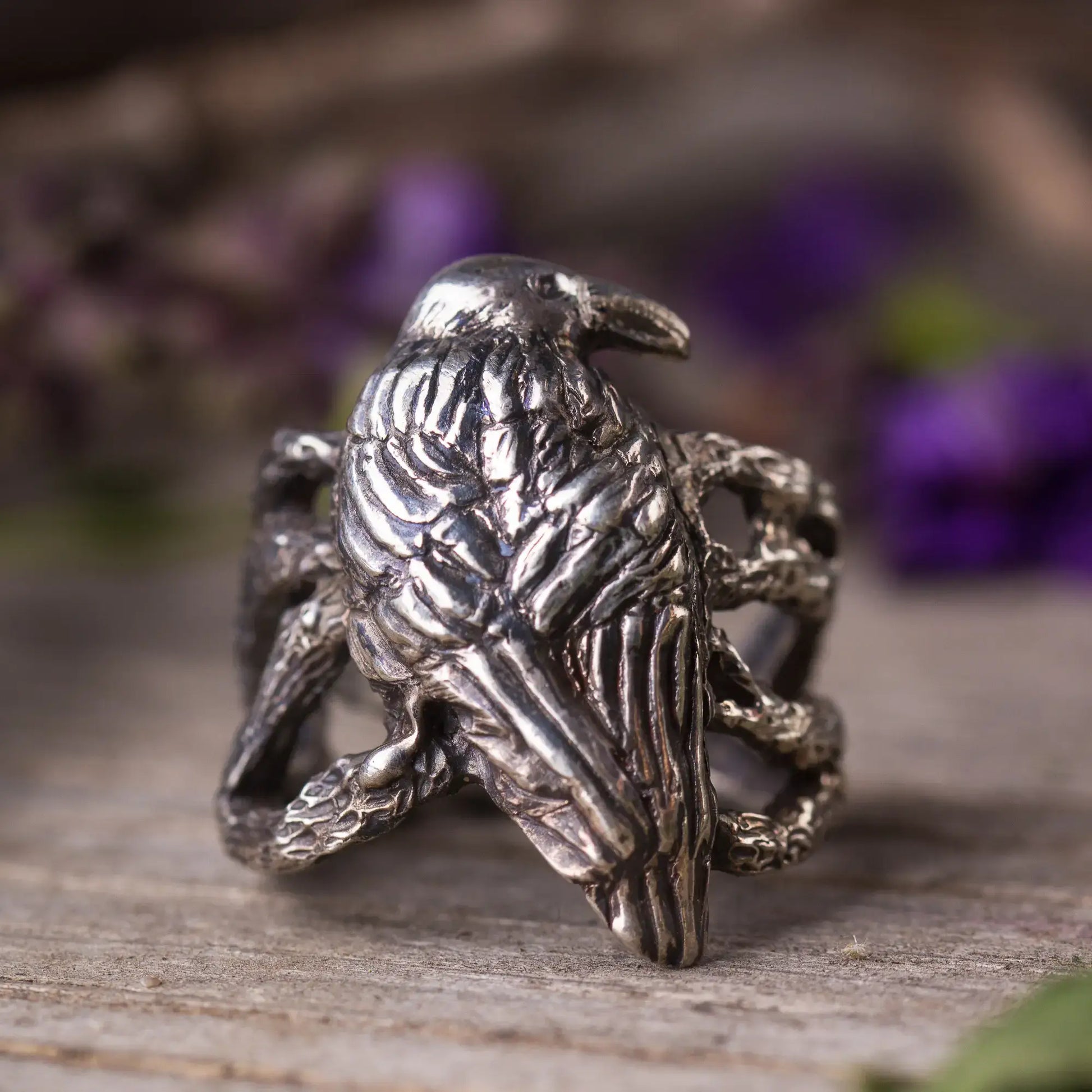 Sterling silver crow ring showcasing intricate bird perched on branches, handcrafted for nature and statement styles.