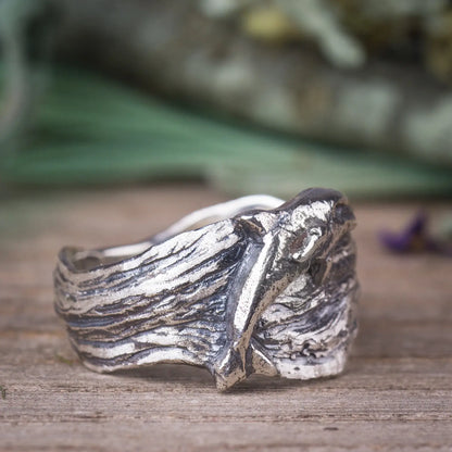 Sterling silver dolphin ring with wide wavy band, featuring a jumping bottlenose dolphin design, perfect for ocean lovers.