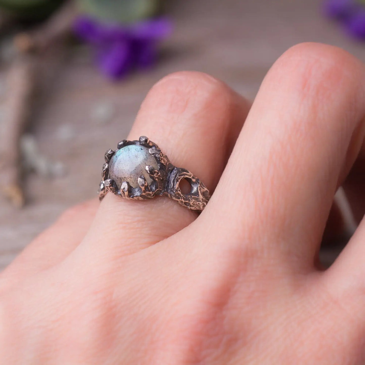 Labradorite twig ring in sterling silver with green witch style on a hand, magical forest-inspired jewelry with rough cut gemstone.