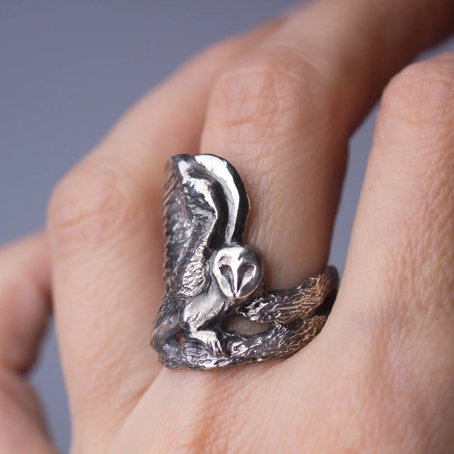 Barn Owl Ring in Sterling Silver with spreading wings, hand-carved bird statement ring on finger.