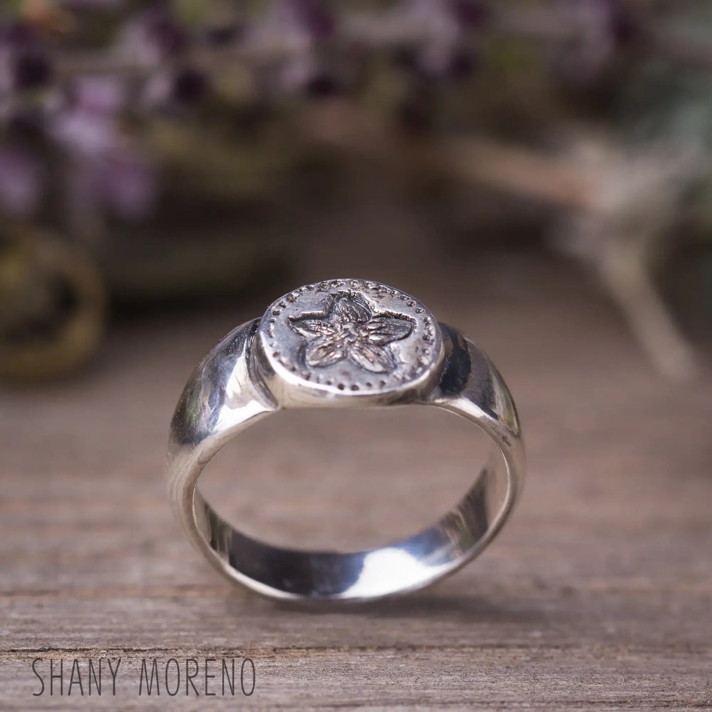 Antique style sterling silver signet ring with hand-carved scarlet Pimpernel flower design, capturing dainty natural beauty.