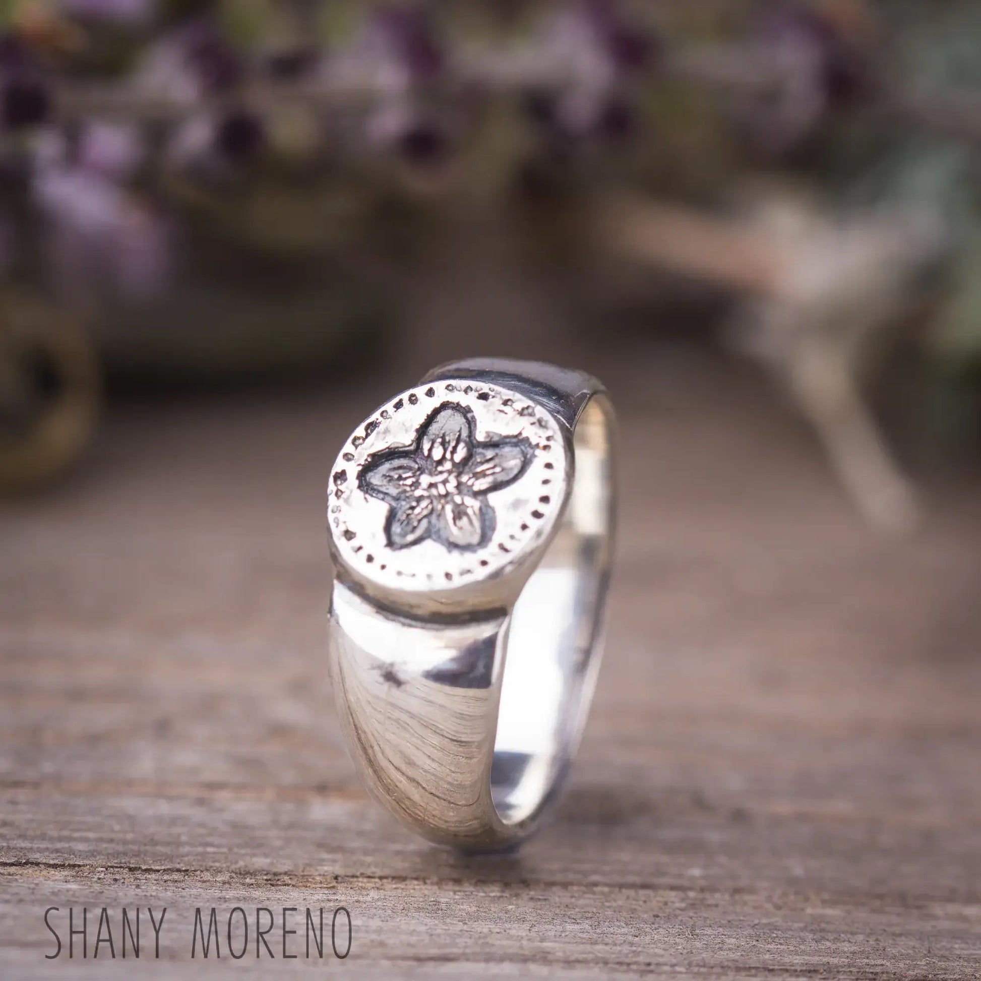 Antique style sterling silver signet ring with hand-carved pimpernel flower design, showcasing dainty and natural beauty.