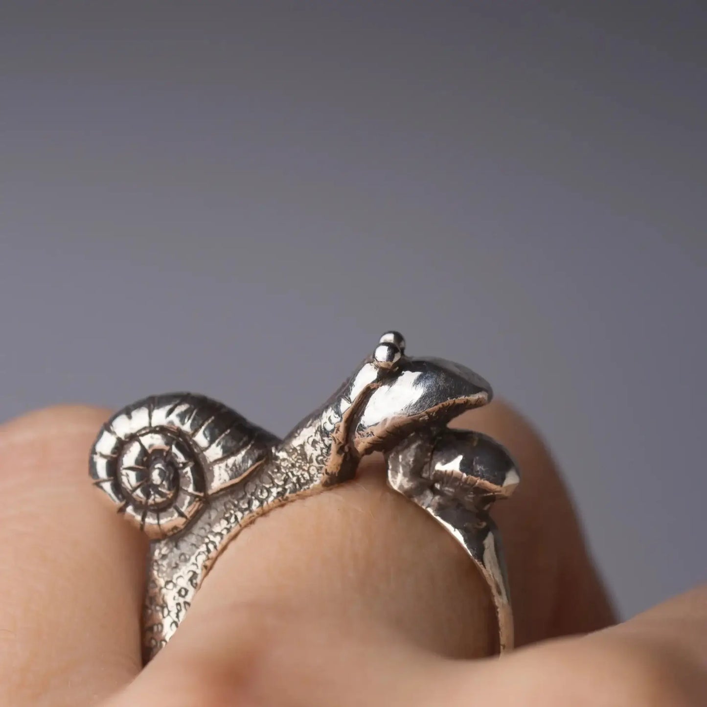 Silver snail and mushroom handcrafted ring, woodland jewelry, featuring a cute animal motif on finger.