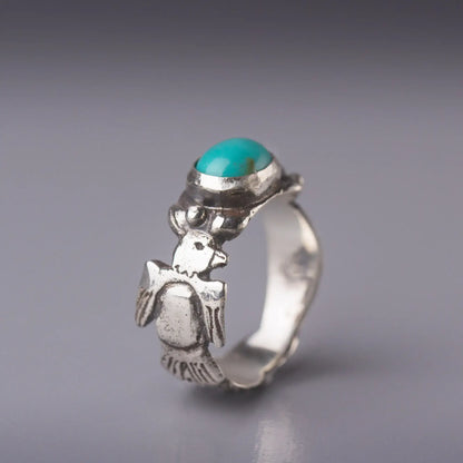 Thunderbird ring with turquoise oval gemstone and feather design in sterling silver, embodying Southwestern spirit, strength, and freedom.