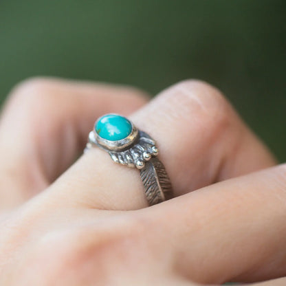 Thunderbird Turquoise Sterling Silver Ring with Feather Design on hand