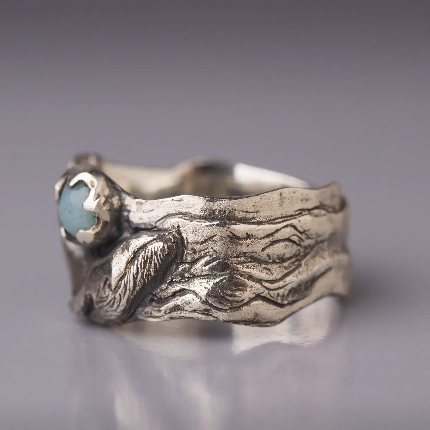 Sterling silver humpback whale ring with amazonite gemstone and wide band, side view.