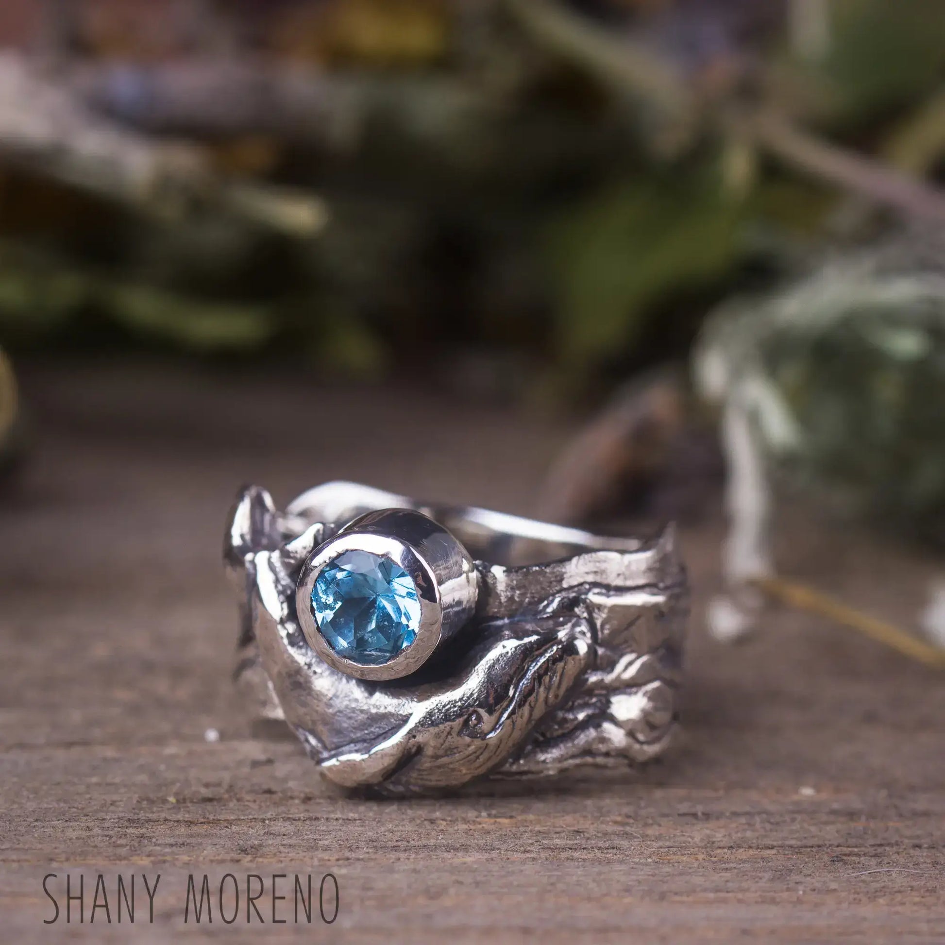 Sterling silver whale ring with blue topaz gemstone and wide band, perfect for ocean lovers and nautical style enthusiasts.