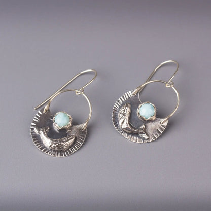 Sterling silver humpback whale dangle earrings with Larimar gemstones, ocean-inspired statement jewelry.