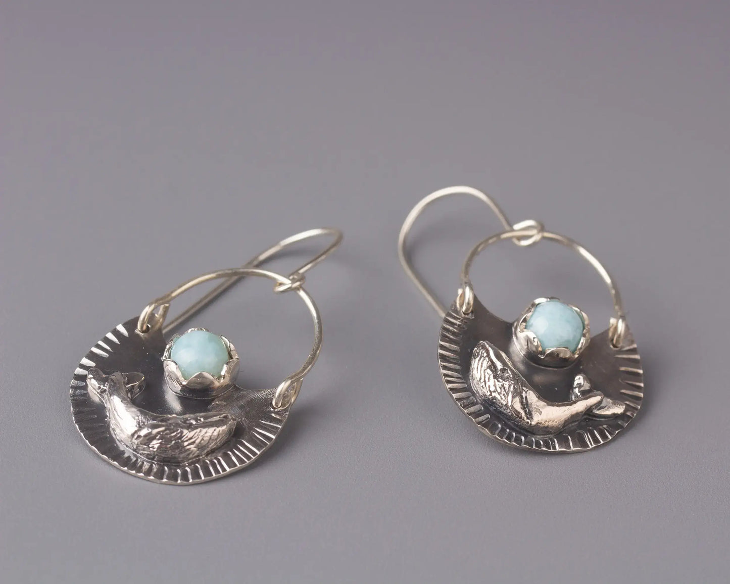 Silver humpback whale dangle earrings with larimar gemstones, ocean inspired statement jewelry.