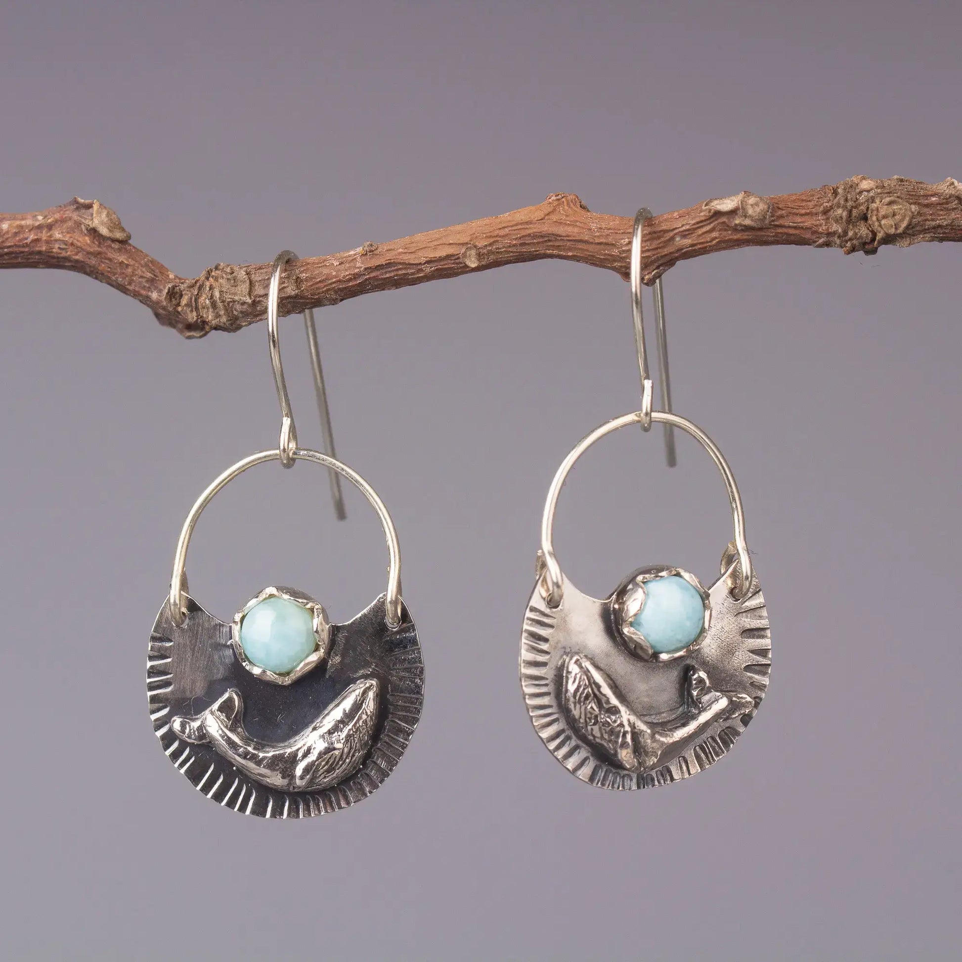 Humpback whale dangle earrings in silver with Larimar gemstones, ocean style statement jewelry on display.