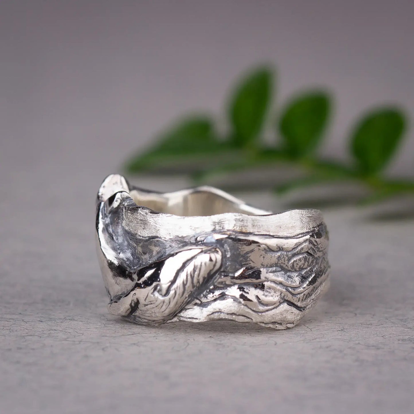 Whale ring in sterling silver featuring humpback whale design on wide band ring, ocean-inspired jewelry with detailed sea animal.