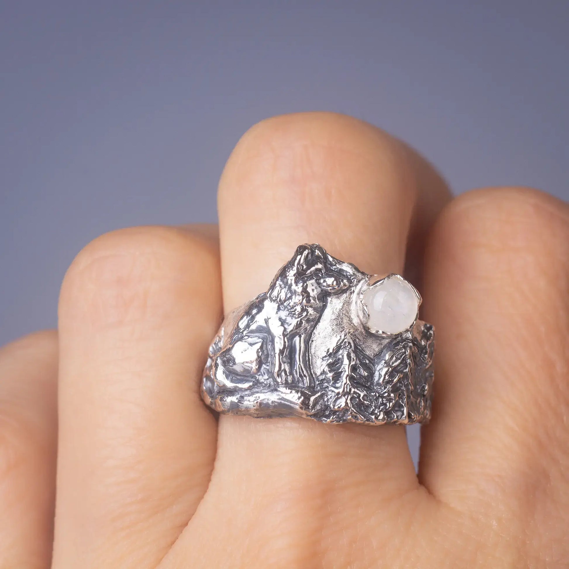 wolf ring in silver with moonstone worn on finger